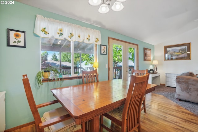 dining area featuring lofted ceiling and a chandelier