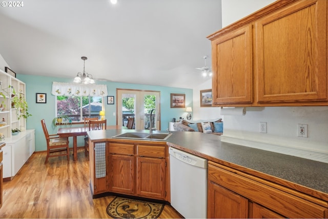 kitchen with pendant lighting, sink, light hardwood / wood-style flooring, dishwasher, and an inviting chandelier