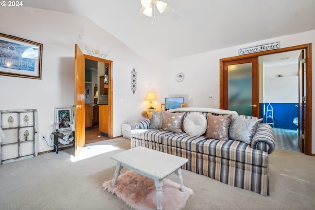 living room featuring lofted ceiling, light carpet, and ceiling fan