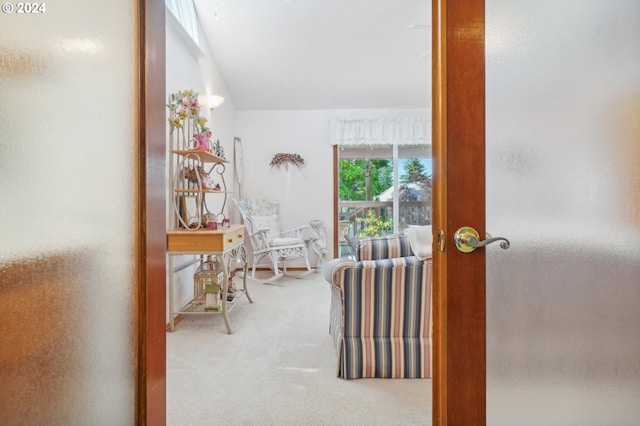 hallway with lofted ceiling and carpet flooring