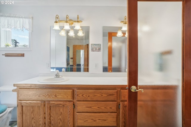 bathroom featuring vanity, toilet, and an enclosed shower