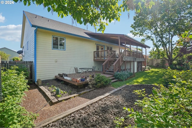 back of house featuring a yard and a deck