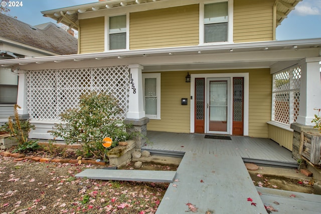 view of exterior entry with a porch