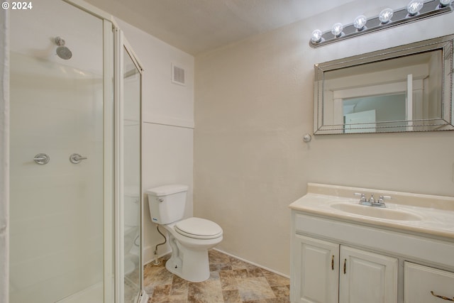 full bathroom featuring visible vents, a shower stall, baseboards, toilet, and vanity