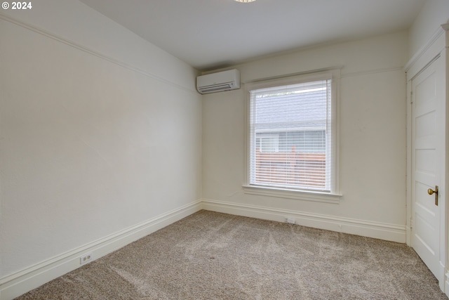 unfurnished room featuring a wall mounted air conditioner and light carpet