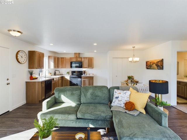 living room featuring dark wood-type flooring and a notable chandelier