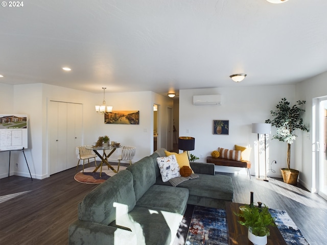 living room featuring hardwood / wood-style flooring, a notable chandelier, and a wall unit AC