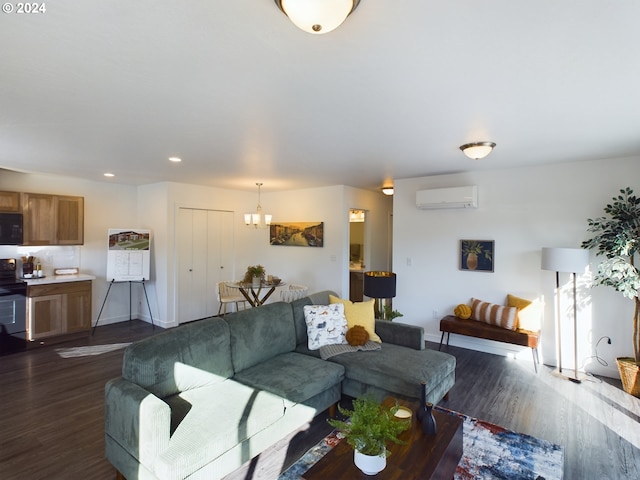 living room featuring dark hardwood / wood-style flooring, a wall unit AC, and a notable chandelier