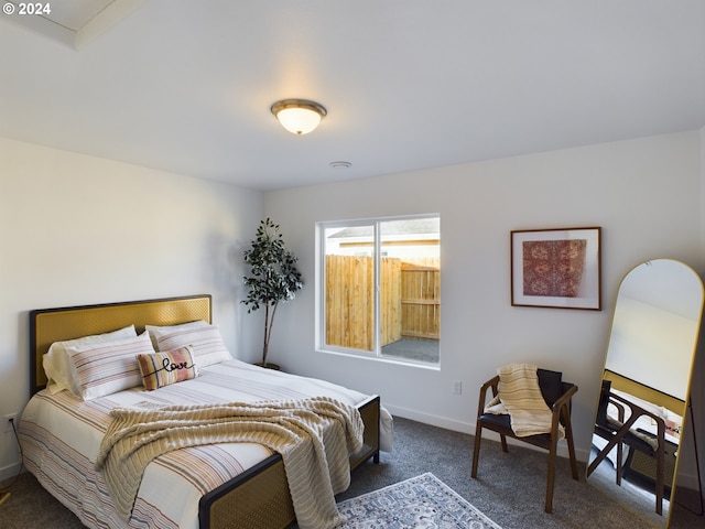 bedroom with dark colored carpet