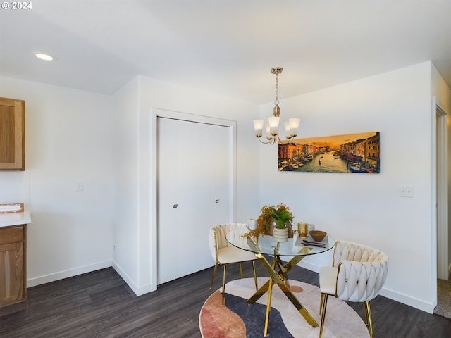 dining room with dark wood-type flooring and a chandelier