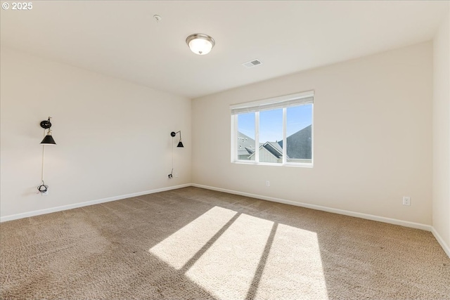 carpeted empty room featuring visible vents and baseboards