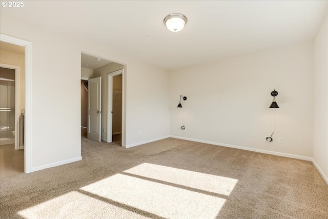 spare room featuring baseboards and carpet flooring