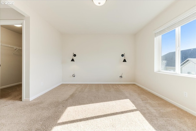 laundry room with carpet and baseboards