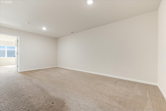 spare room featuring baseboards, recessed lighting, visible vents, and light colored carpet