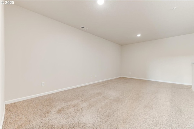 empty room with carpet floors, recessed lighting, visible vents, and baseboards