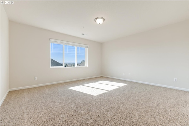 unfurnished room with light carpet and baseboards