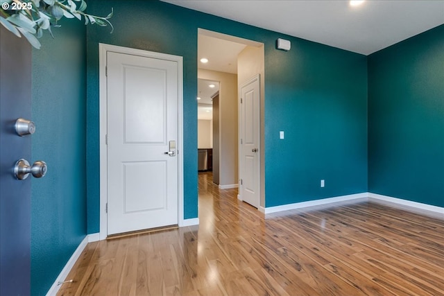 unfurnished bedroom featuring wood finished floors and baseboards