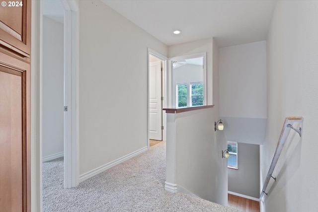 hall with recessed lighting, carpet, and baseboards