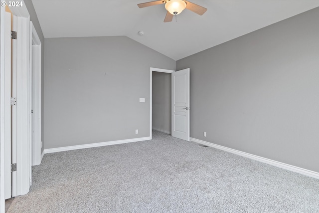 unfurnished bedroom with vaulted ceiling, carpet flooring, baseboards, and ceiling fan