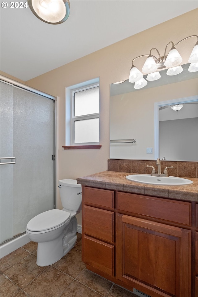 full bath featuring vanity, toilet, a shower stall, and tile patterned flooring