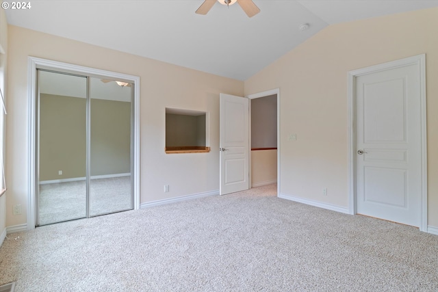 unfurnished bedroom with carpet, baseboards, lofted ceiling, ceiling fan, and a closet