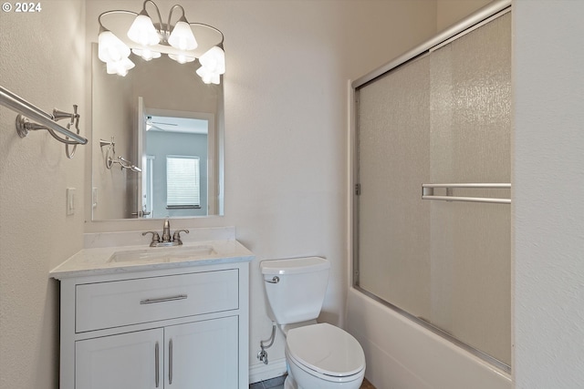 bathroom featuring enclosed tub / shower combo, toilet, and vanity