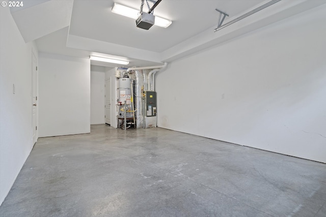 garage featuring a garage door opener and water heater