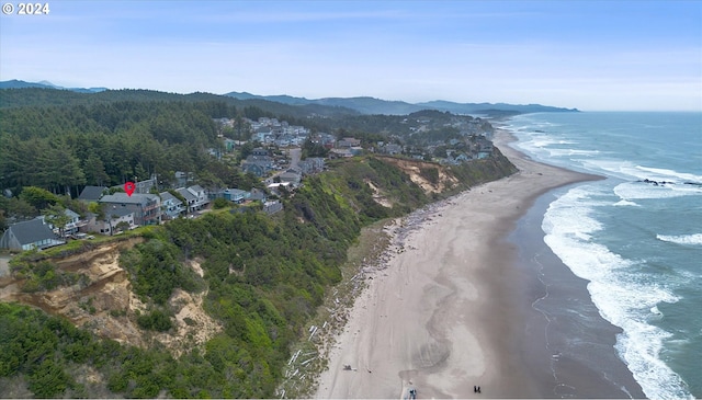 drone / aerial view with a beach view and a water view