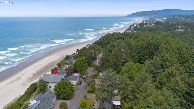 birds eye view of property featuring a beach view and a water view