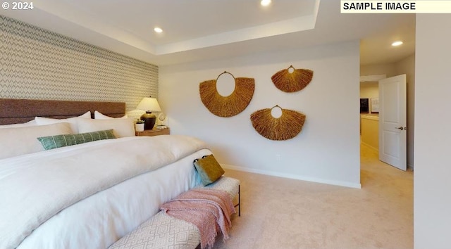 bedroom featuring carpet and a tray ceiling