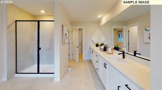 bathroom featuring tile patterned floors, vanity, and walk in shower