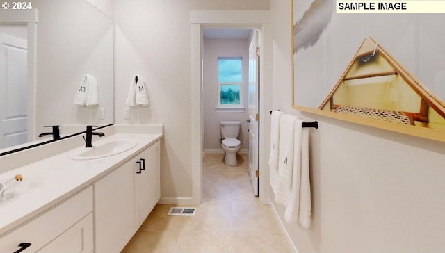 bathroom featuring tile patterned floors, vanity, and toilet