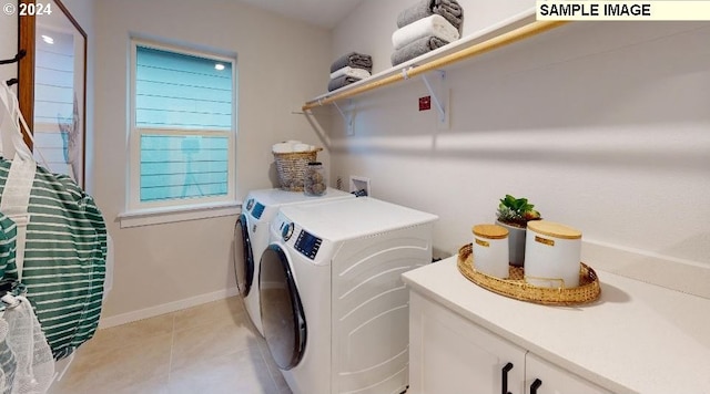 clothes washing area featuring washing machine and dryer and light tile patterned flooring