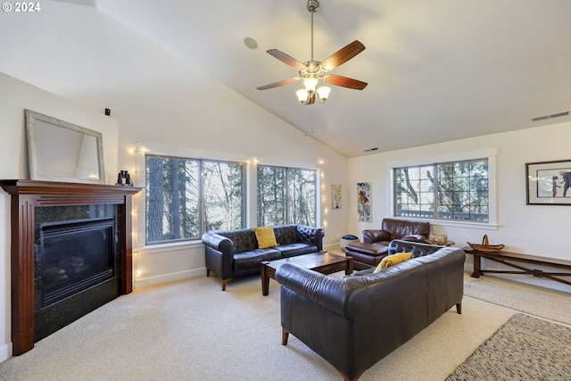 carpeted living room featuring ceiling fan, a premium fireplace, and high vaulted ceiling