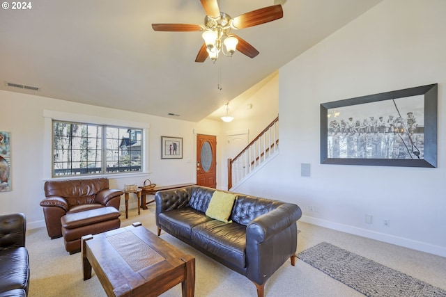 living room with ceiling fan, light colored carpet, and vaulted ceiling