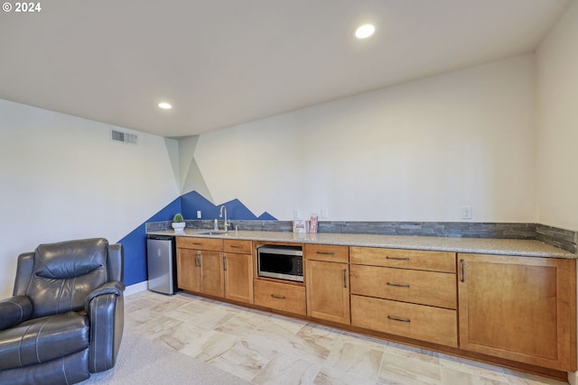 kitchen with light carpet, appliances with stainless steel finishes, and sink