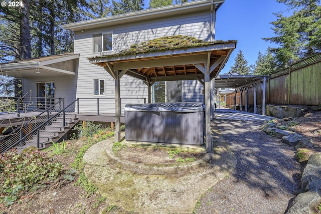 exterior space featuring a hot tub and a gazebo