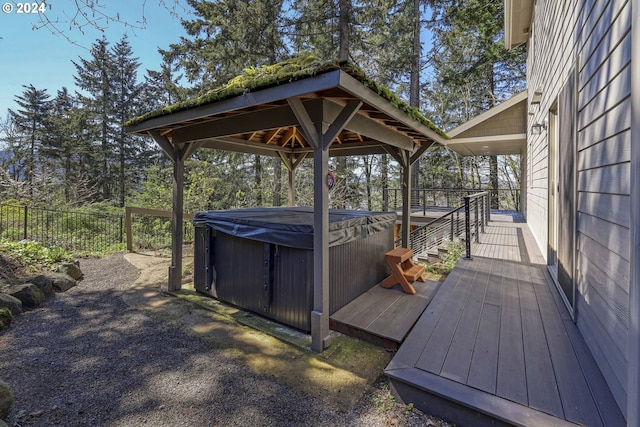 wooden terrace with a gazebo and a hot tub