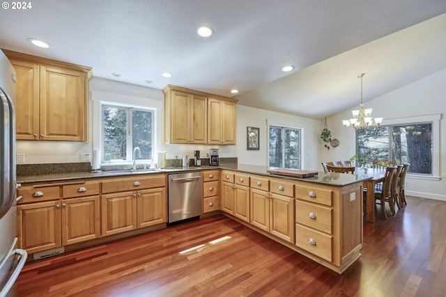 kitchen featuring dishwasher, a chandelier, vaulted ceiling, kitchen peninsula, and decorative light fixtures