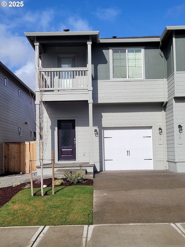 view of front facade featuring driveway, a garage, a balcony, fence, and a front lawn