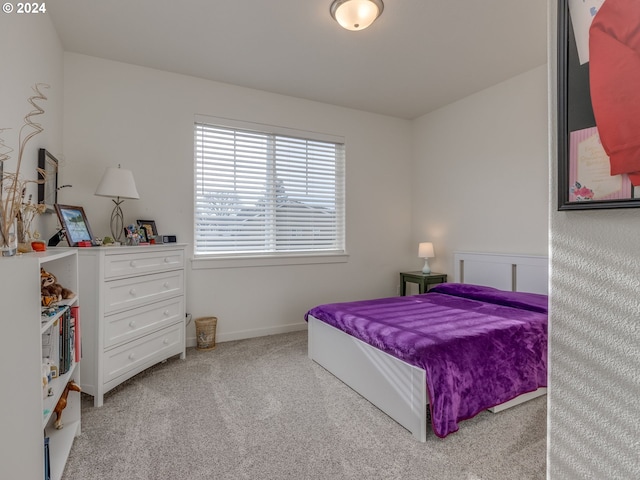 bedroom featuring light colored carpet