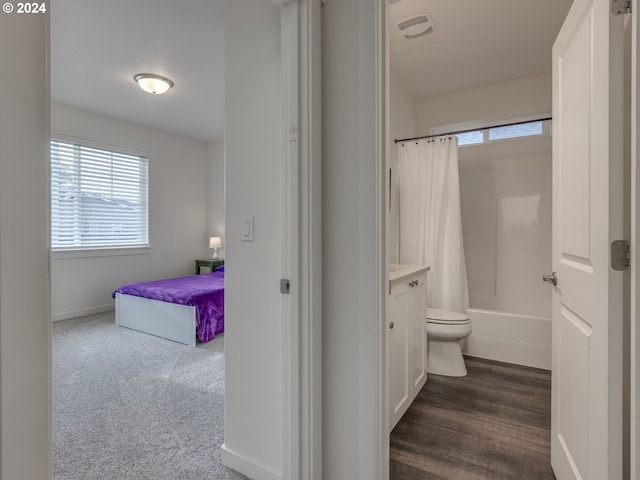 bathroom with shower / tub combo with curtain and toilet