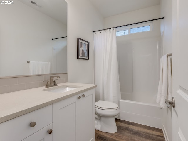 full bathroom with shower / bath combo, backsplash, toilet, vanity, and hardwood / wood-style flooring