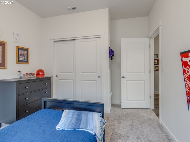 carpeted bedroom featuring a closet