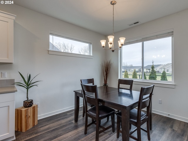 dining area featuring a chandelier and dark wood-type flooring