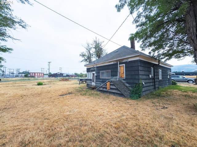 view of side of property with a yard