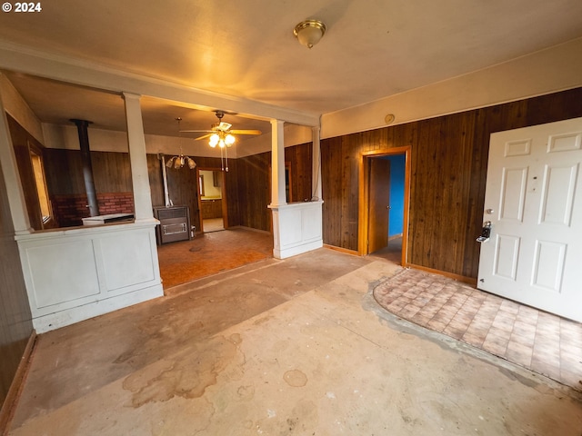 entryway with ceiling fan and wood walls