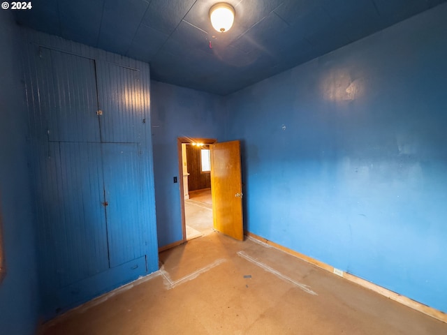 unfurnished bedroom featuring concrete flooring