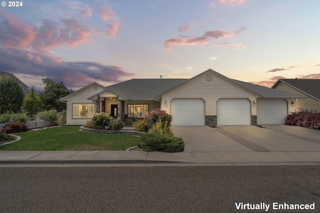 view of front of property with a lawn and a garage