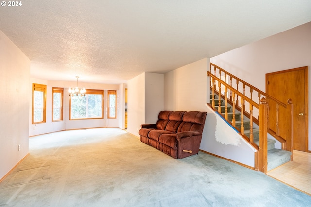 living room featuring a textured ceiling, light carpet, and a chandelier